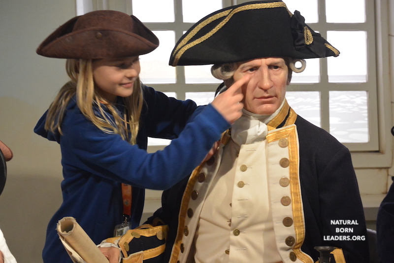 a boy dressed up in a pirate hat touching a wax figure explorer - example how creative expression promotes entrepreneurial spirit