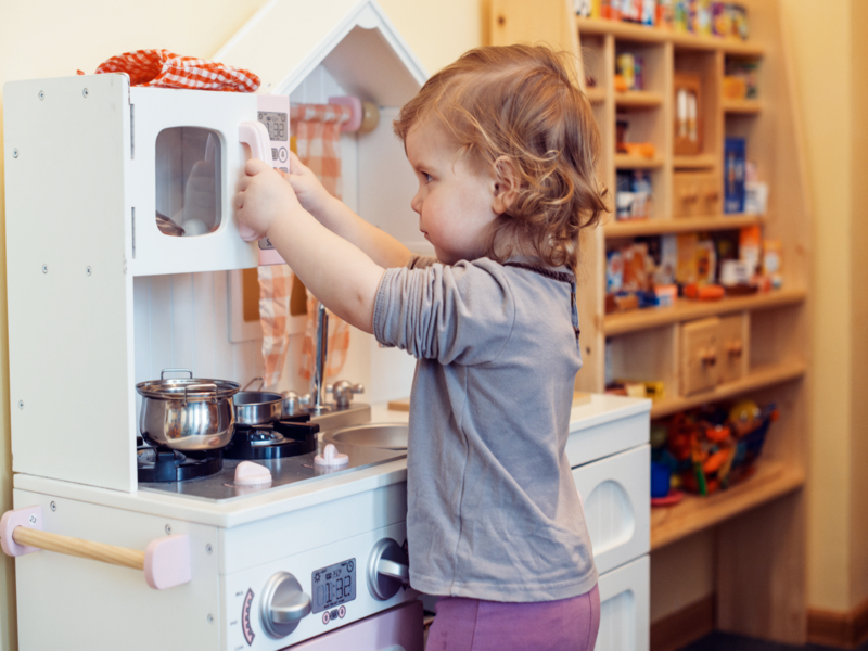 role play early childhood girl playing kitchen